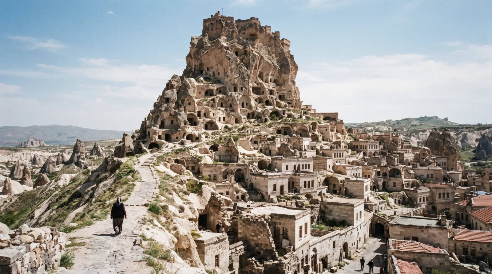 The rock castle of Ortahisar rising over the stone houses of the town, Cappadocia