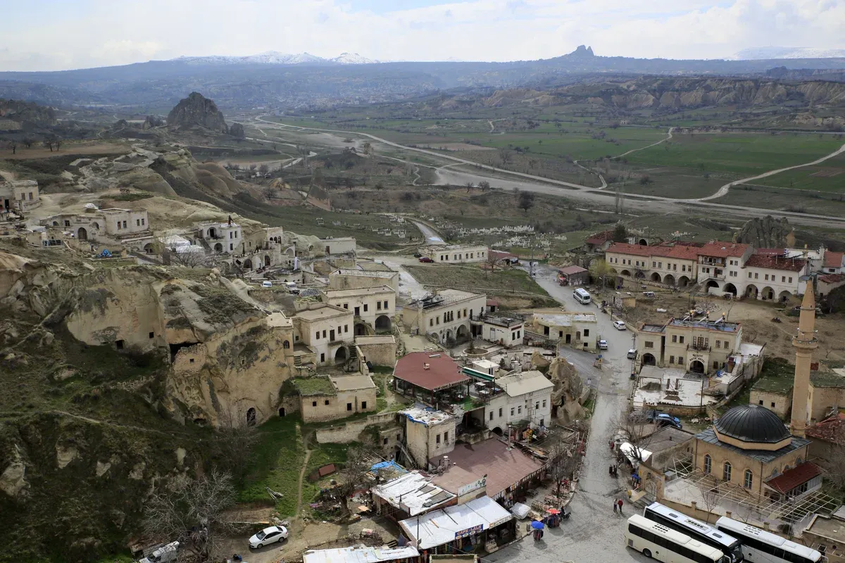 The rock church and cave houses of Çavuşin under the castle ridge